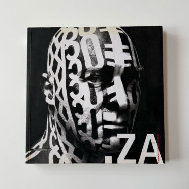 Cover of ZA: Giovane Arte Dal Sudafrica featuring a black and white portrait with layered typography, representing a survey of South African contemporary art