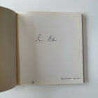 Front cover of the photography book "Shadow Chamber" by Roger Ballen, showing a monochromatic image of a man and wire tangle, signed softcover edition published by Phaidon.