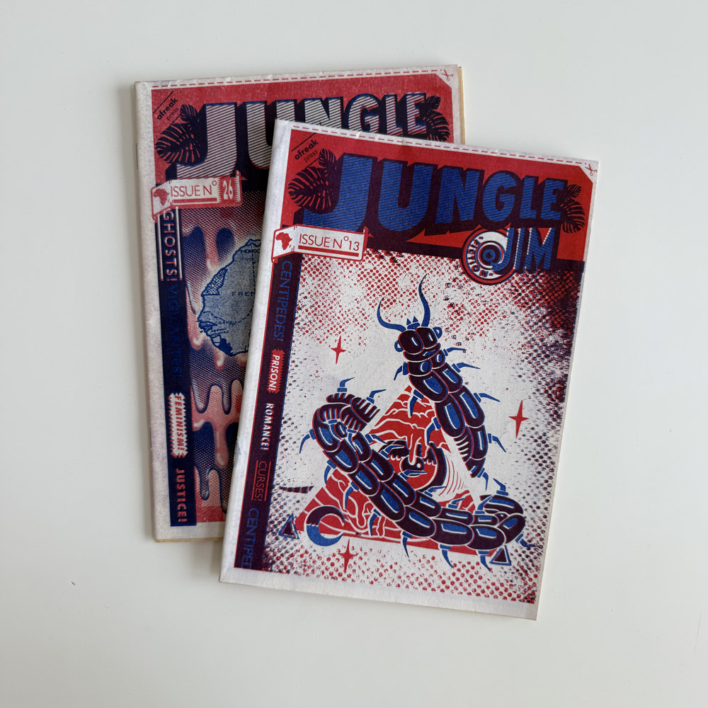 jungle-jim-pulp-fiction-zine-afreak-press Two vintage issues of Jungle Jim African pulp fiction zine (No. 13 and No. 26) printed via red and blue risograph on newsprint, stacked on a white surface.