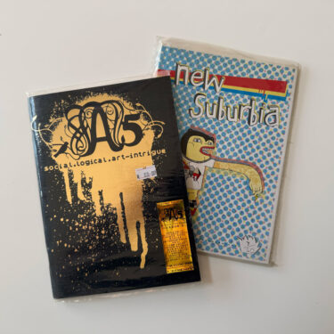 wo extremely rare, plastic-sealed mid-2000s South African art zines by Love and Hate Studio: A5 Issue 1 (1 of 350) and New Suburbia (7 of 50).